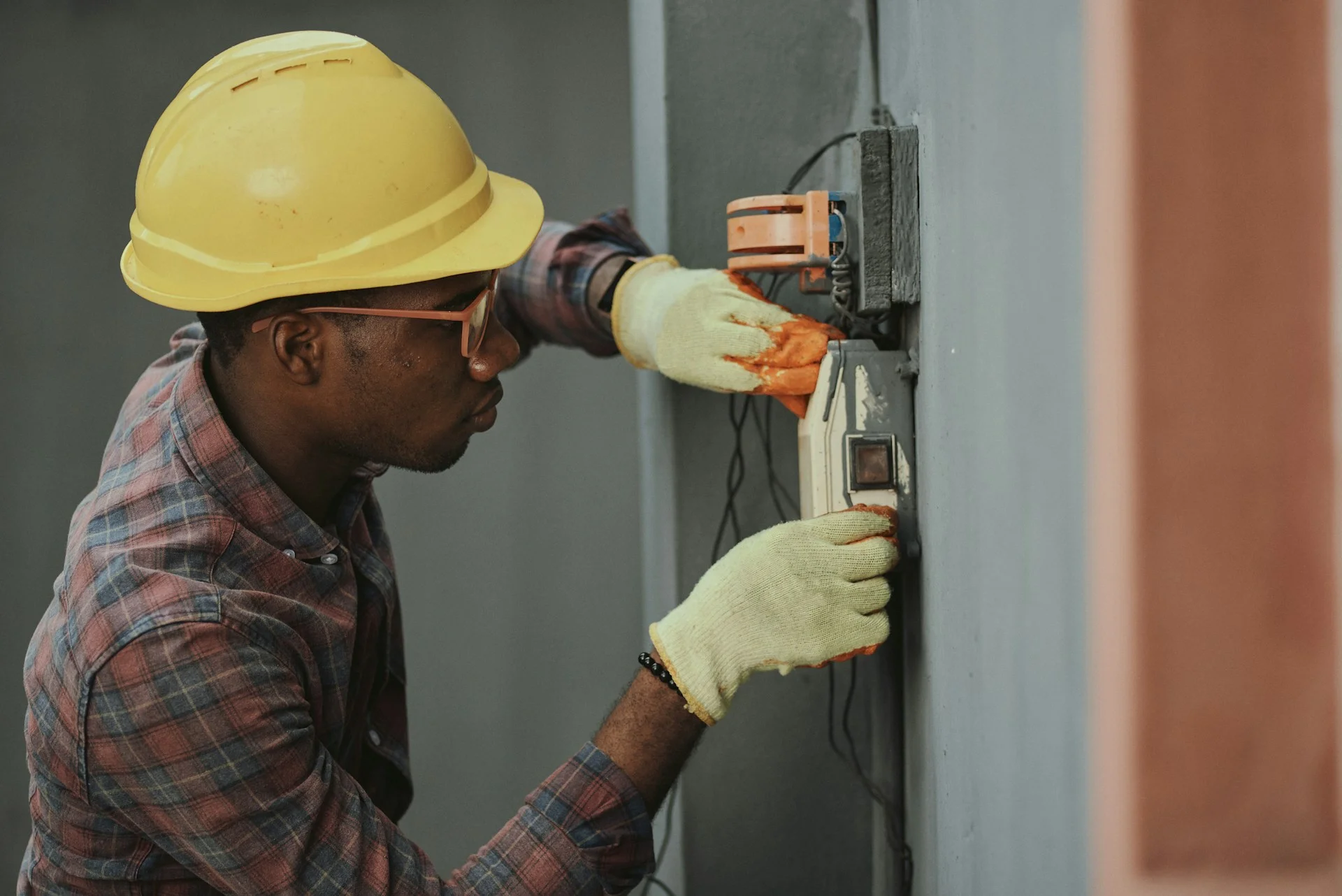 Professional electrician working on electrical panel installation